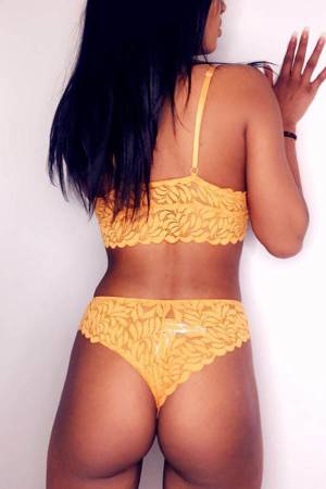 back view of CHLOE wearing a yellow lingerie set